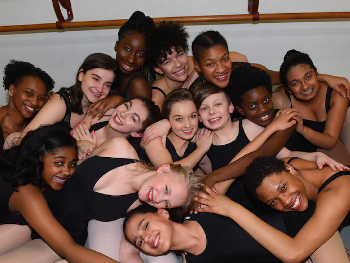 a diverse group of youth dancers posing for the camera
